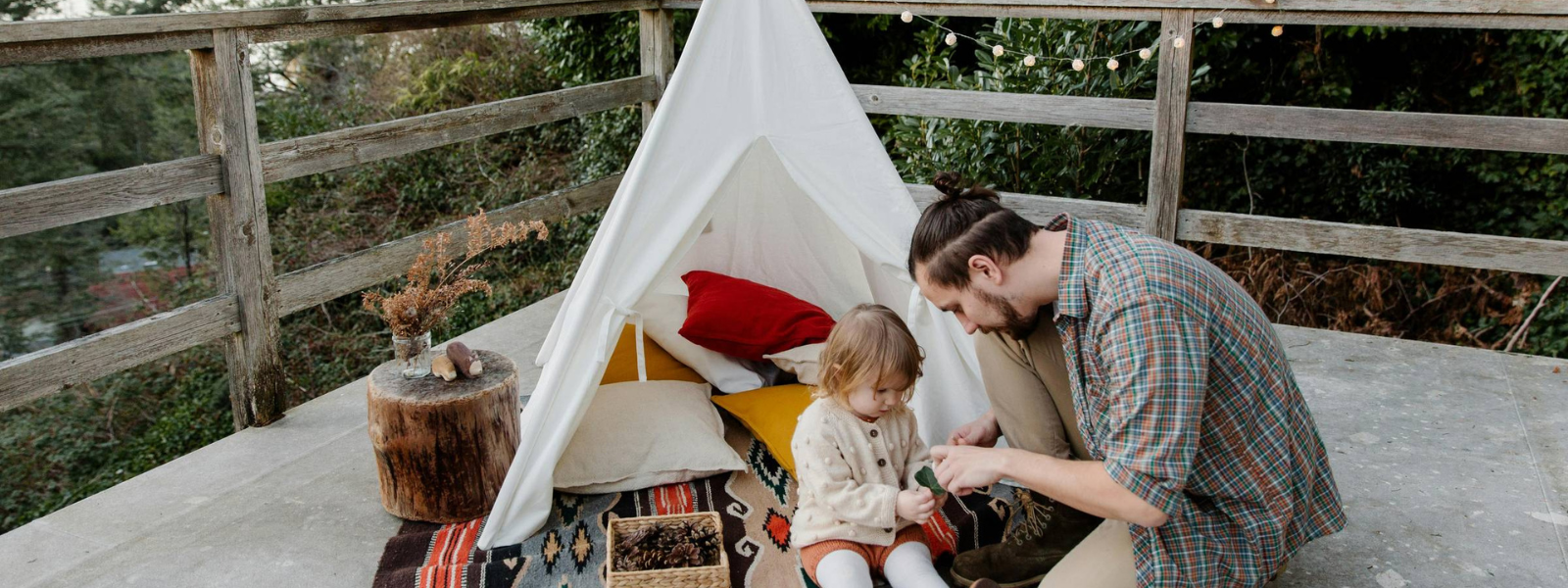 father with daughter connecting while playing on a porch